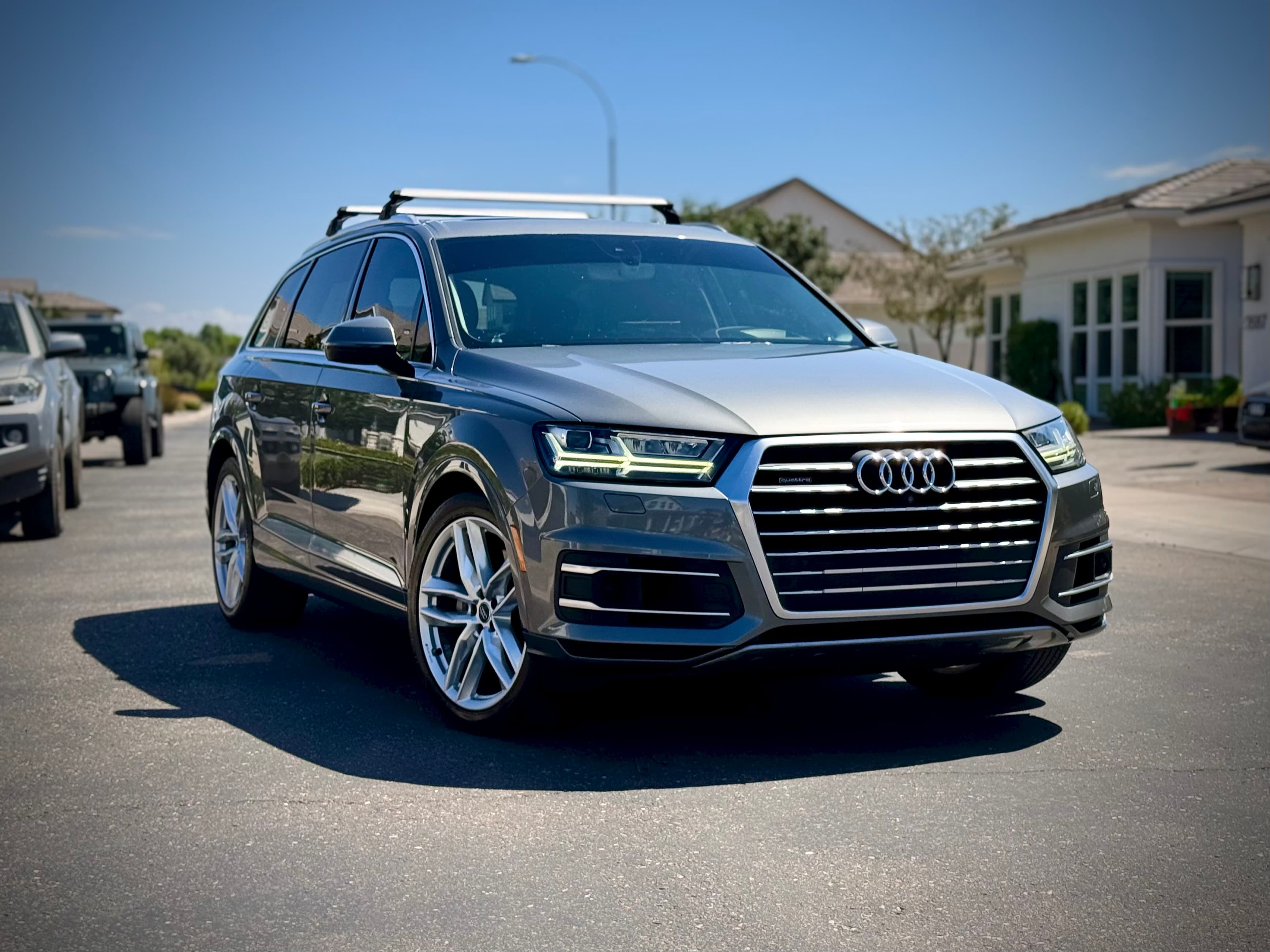 Freshly detailed gray Audi Q7 parked on a residential street