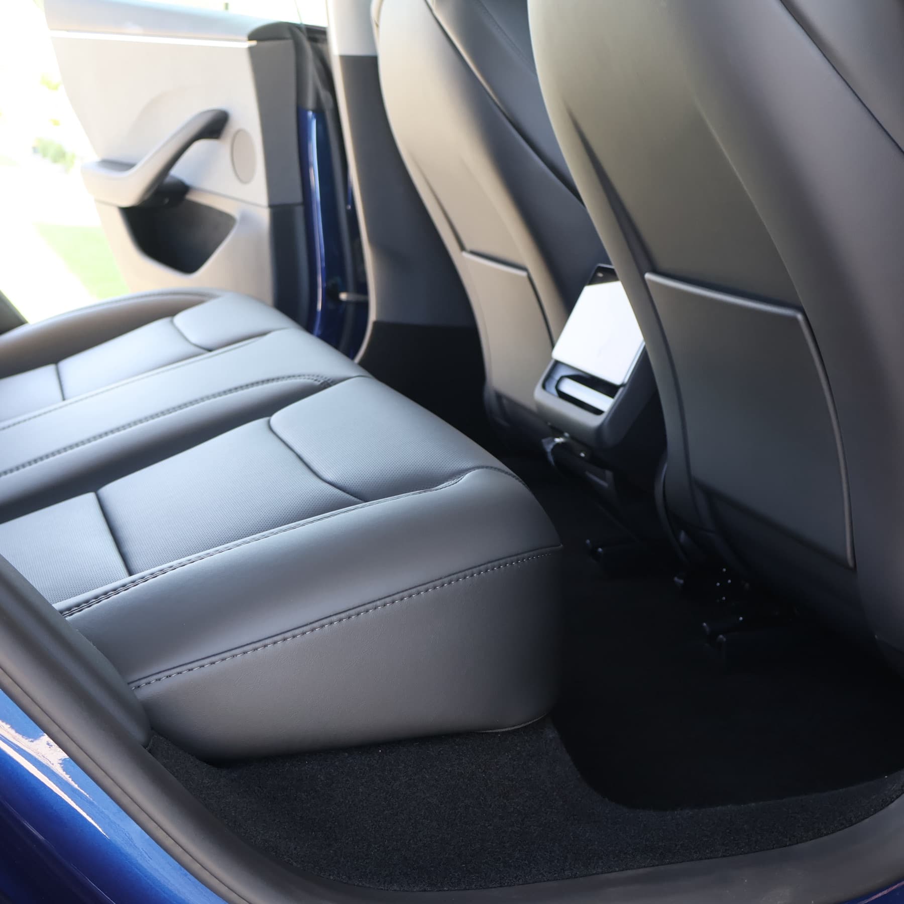 Rear seat and floor of a blue sedan, leather and carpet cleaned