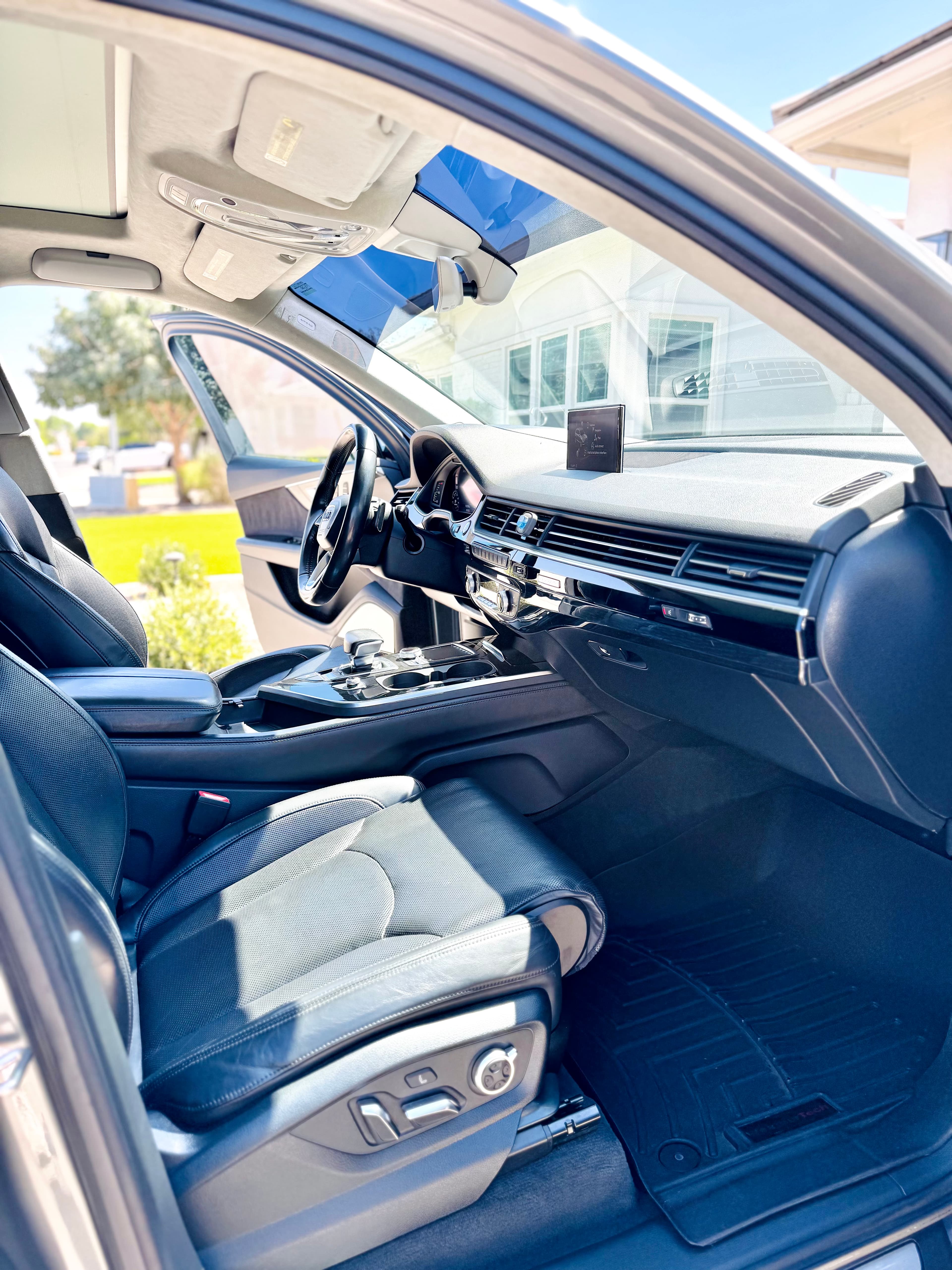 Detailed Audi front cabin with clean dashboard, center console and leather passenger seat