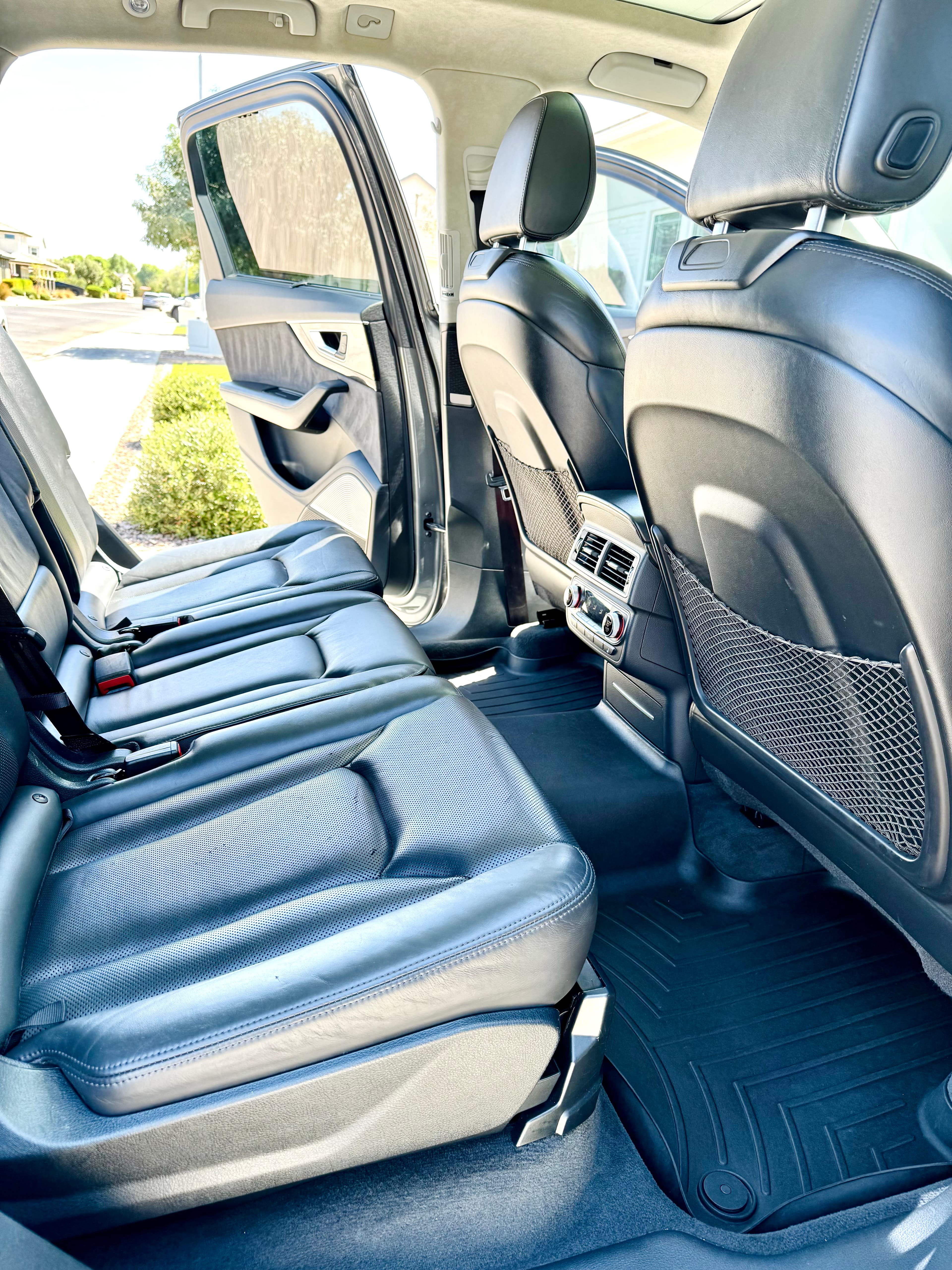 Detailed Audi rear cabin with clean leather seats, floor mats and rear console
